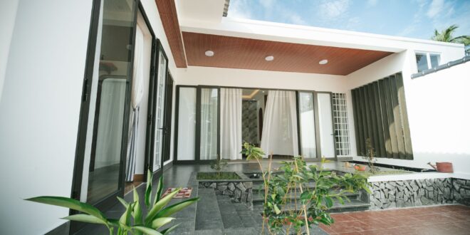 Rumah satu lantai mewah dengan desain modern, kolam renang, taman tropis, dan pencahayaan alami yang elegan.
